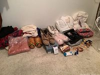 Full lot view showing robes, sweaters, shoes including clogs, slippers, bangles, hair dryer kit bag