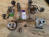 Overview of all candlesticks and candle snuffers on the floor, showing condition and relative size.