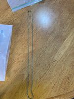 Full view of the 28-inch box chain necklace laid out on a wood surface