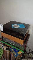 Philips turntable with wooden base and transparent dust cover, manual on top