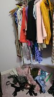 Hanging women's dresses and clothing in various colors and patterns on hangers