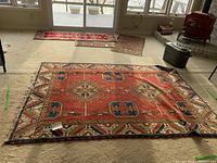 Full view of rug laid flat on carpeted floor beneath windows