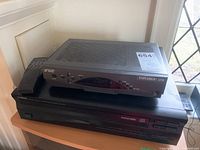 Yamaha CDC-575 CD player with Scientific Atlanta Explorer SA4290SD TV box stacked on top.