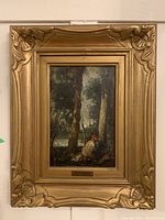 Full front view of gold-framed landscape painting