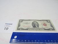 Front view of the 1953 B $2 bill with ruler for scale. The red Treasury seal and serial number A71894560A are visible.