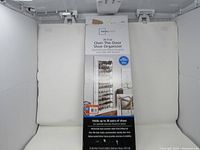 Photo of the boxed new Over-the-Door Shoe Organizer showing front of package with product name and shoe holding capacity.