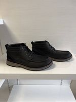 Side view of both black ankle boots showing full profile, laces, stitching details, and soles.