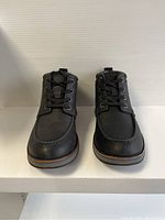 Front view of black men's ankle boots size 9, showing moc toe design and laces.
