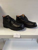 Side view of the black comfort boots showing lace-up design and padded collar, size 40XW.
