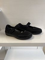 Side view showing black Orthofeet ladies shoes with mesh and suede materials, adjustable strap and thick sole