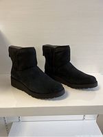 Front angle of the new women's UGG boots in black suede showing styling and shape.