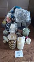 Lot of fragrance and candle items including candles, tealight pack, spray dispenser, candle holders, nightlight, and salt lamp.