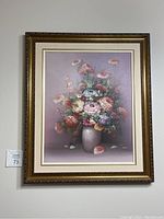 Full frontal view of framed floral oil painting hanging on wall showing overall condition and frame details.