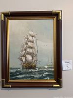 Full view of framed sailing ship painting on canvas.