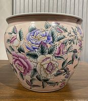 Front view showing the entire pot with floral design on the exterior surface.