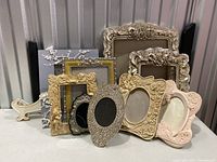 Photo showing all 9 frames arranged together, some leaning on each other, various sizes and materials apparent.