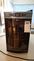 Front view of Koolatron electric wine cooler with control panel and glass door