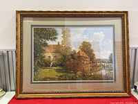 Full view of the framed print showing the art and gold frame