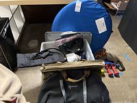 Lot layout with stacked cooler bags, blue collapsible shelter, weighted barbells and various smaller equipment pieces.