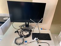 Full view of the ASUS ProArt monitor with cables, SMK-Link wireless keyboard, USB personal fan, and Targus adjustable stand visible.