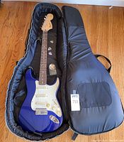 Guitar and accessories laid inside padded gig bag