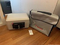 Full view of the Sentry small safe and Roloway fireproof bag on wooden floor