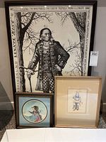 Full view of the three framed Native American themed artworks together to show scale and condition.