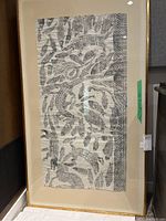 Full view of the framed black and white rubbing artwork showing the entire rubbing and frame.