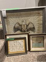 Four framed artworks displayed together on carpet