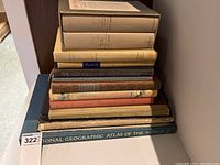 Stack of 12 hardcover books, showing worn spines and varied bindings.