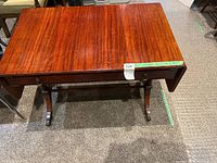 Top view of the claw foot desk showing the polished wood surface and the dimensions label on the side.