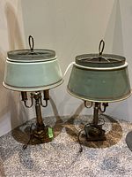 Pair of two metal lamps with slightly different shades and brass-style bases.