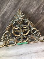 Front view of the wall hanging showing full ornate floral and scrolling design with measurements visible.