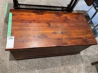 Top view of the cedar wood trunk showing wood grain and surface.