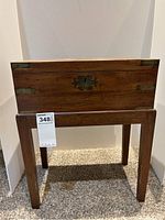 Front view of closed writing desk on its stand