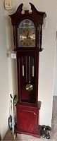Full view of the 6-foot tall grandmother clock showing wood finish and general shape.