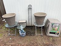 Overview of all items in the lot positioned against a white wall outdoors on dirt ground.