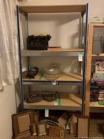 Full view of the shelving unit containing various items, showing the structure and materials.