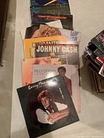 Photo showing a stack of 11 vinyl album covers featuring Barry Manilow, Billy Ocean, Johnny Cash, Peter Paul, Peter Nero and others.
