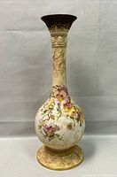 Full view of the 19.5 inch tall porcelain footed vase with hand-painted floral motifs on the mid-body and footed base.