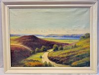 Full view of the framed oil painting showing landscape scene with rolling hills, road, and water in the distance.