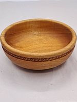 Front-side view of vintage Black Walnut wooden bowl showing decorative band and wood grain.