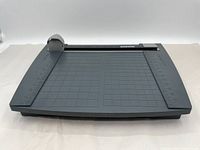 Overall front view showing the gray base with grid pattern and the rotary blade housing on metal rail with Boston branding.