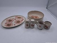 Full group photo showing all six Denby serving pieces with pink flower designs against a white background.