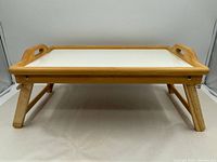 Front view of folding breakfast bed tray with legs extended