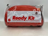 Front view of clear plastic pouch with orange fabric pouch inside labeled Ready Kit 72 Hour Emergency Kit by St John Ambulance.
