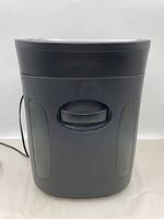 Front and side view of the Royal paper shredder showing the body with handle and power cord.