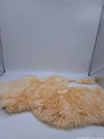 Full view of the vintage sheepskin rug showing the shape and fur texture