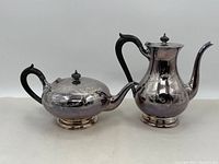 Full view of the silverplate coffee pot and tea pot set showing shape and design.