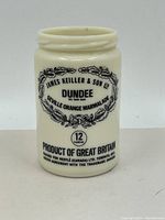 Front view of vintage milk glass marmalade jar with label